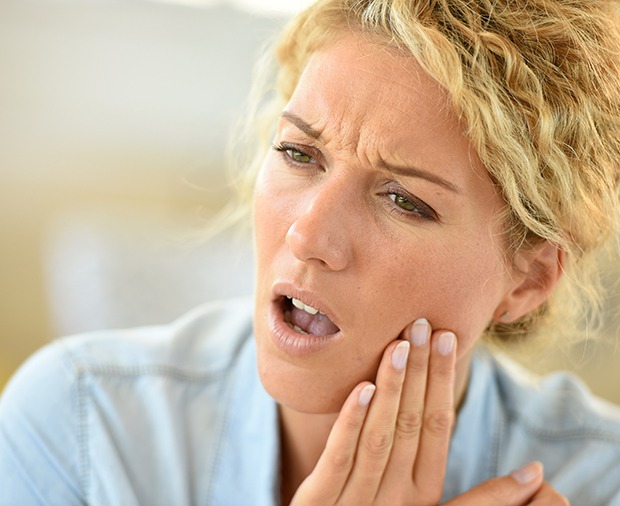 Close-up of blonde woman with toothache