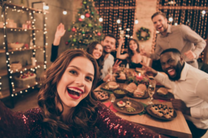 Friends smiling at the camera during a holiday party