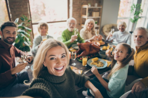 Family posing for a photo at Thanksgiving table